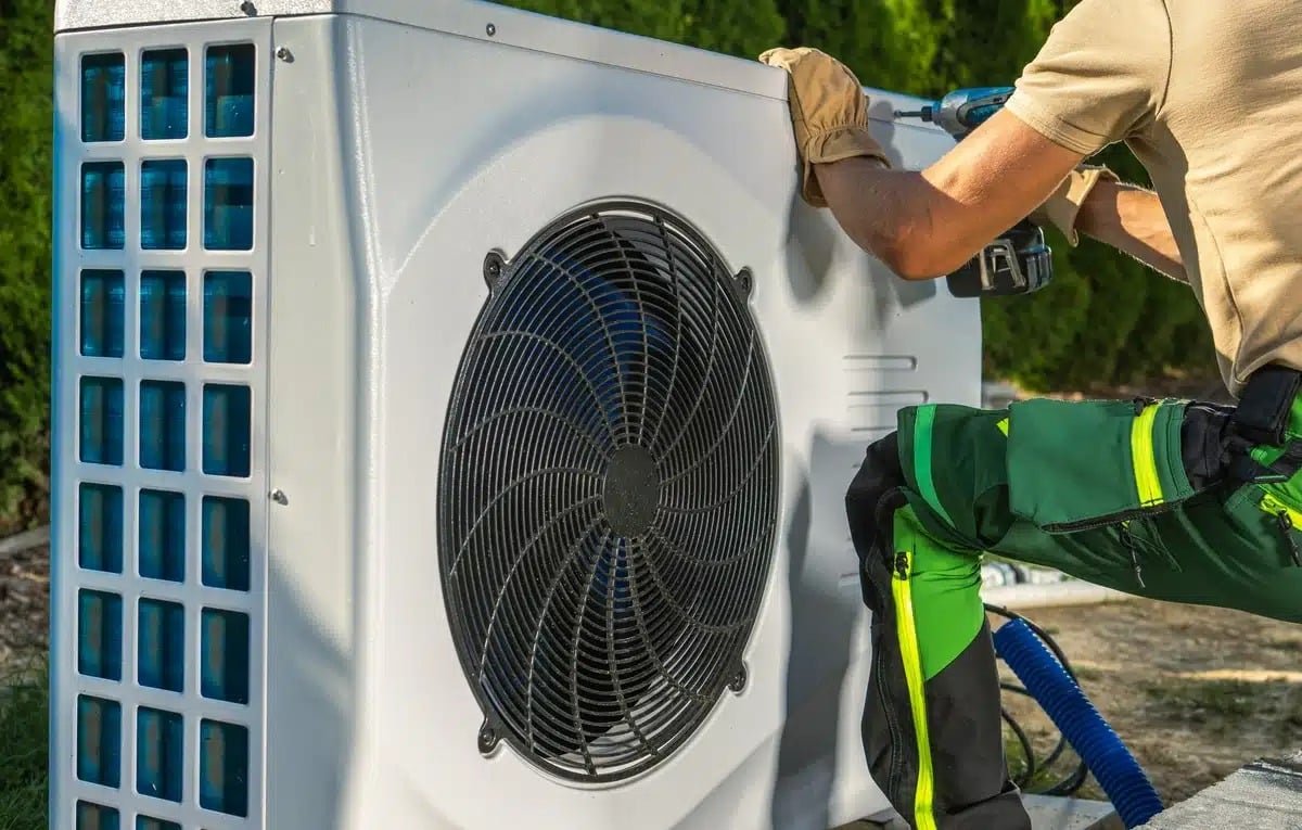 A Professional man Install a Heat Pump