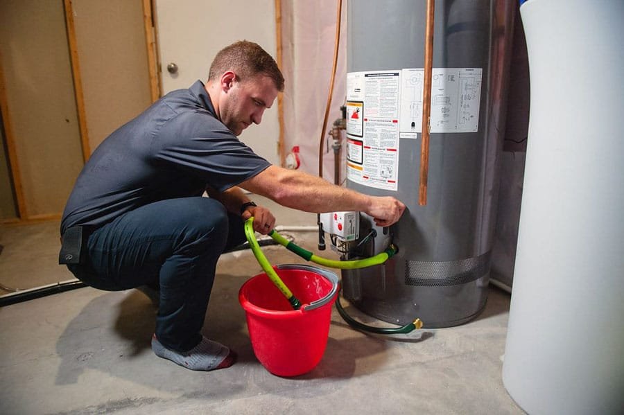 A man Draining the Tank for Optimal Cleaning of water heater