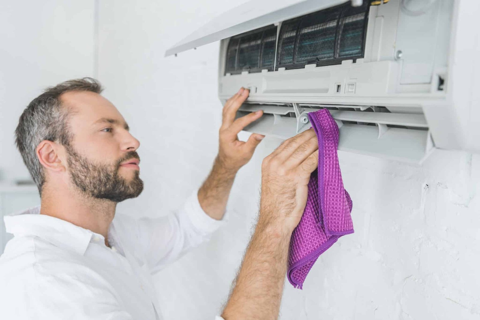 A man cleaning DIY Air Conditioner