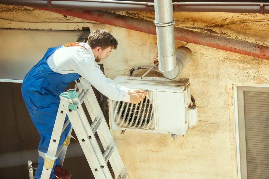 A technician open Heat Pump