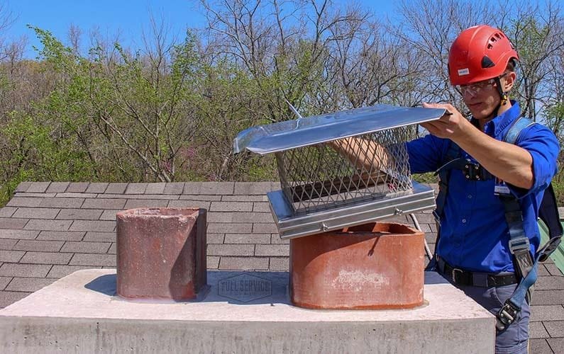 A man Installing the Chimney Cap